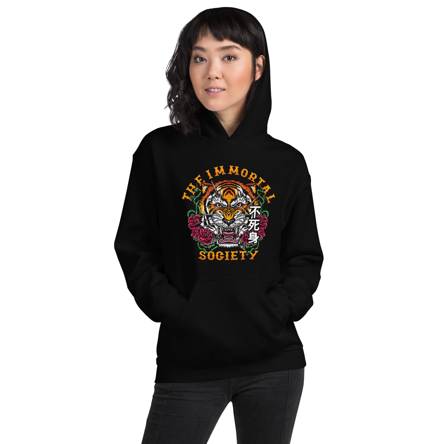 A Asian women wearing a black hoodie with The Immortal Tiger design on it. She is standing in front of a white background.