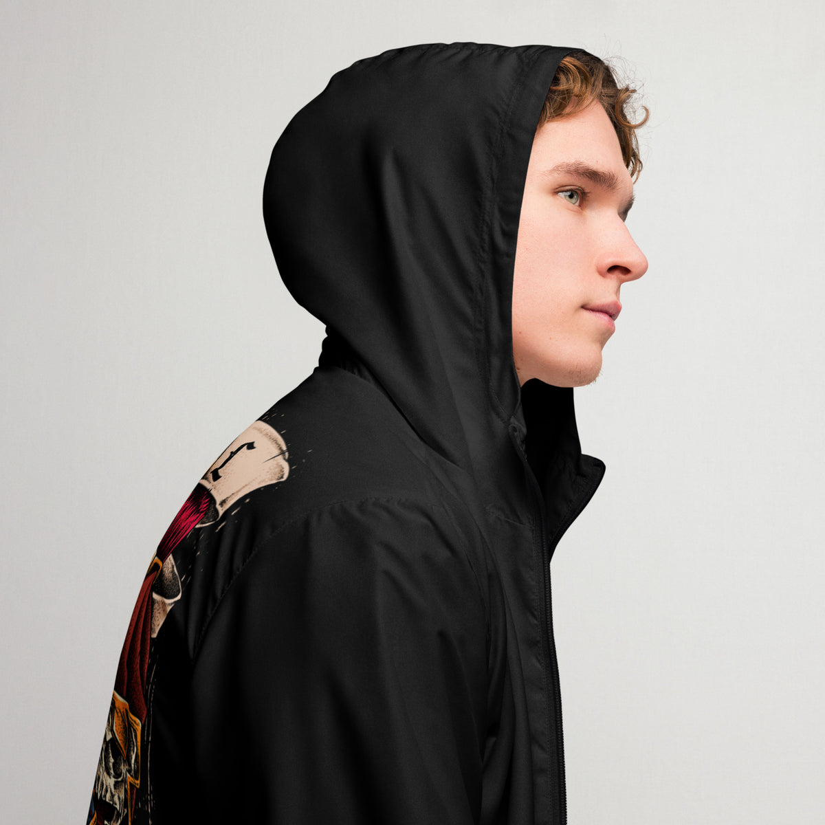 A man wearing a jacket with the hood up. 