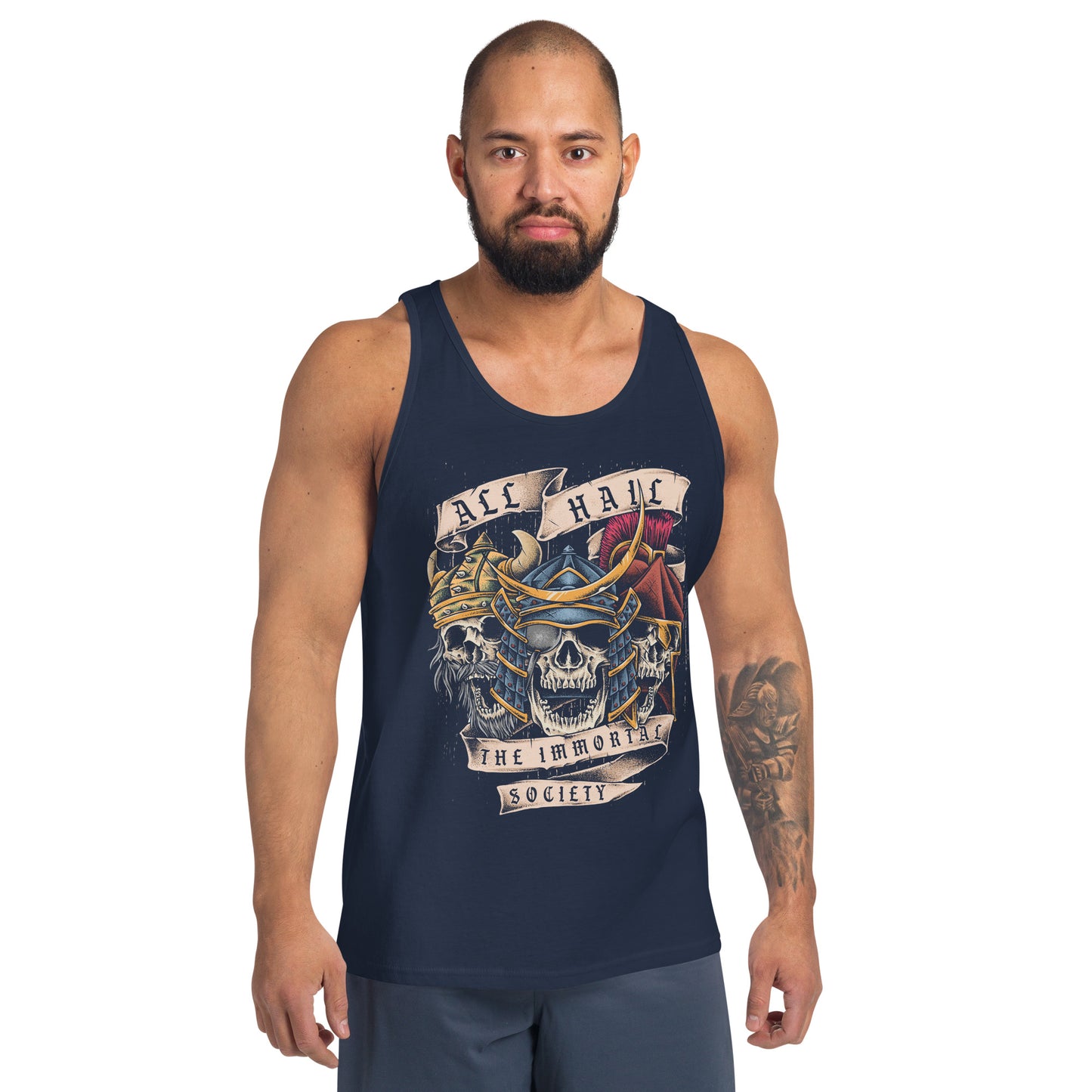 A man with a shaved head and beard wearing a navy colored tank top with The Immortal Warriors design on it. He is standing in front of a white background. 
